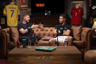 Cristiano Ronaldo and MrBeast in a candid discussion on a leather couch, sharing insights on digital media and global influence.